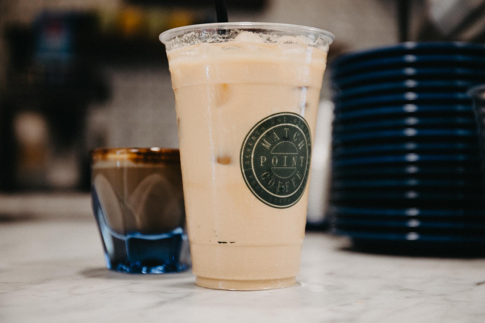 an espresso and iced drink that has match point coffee logo